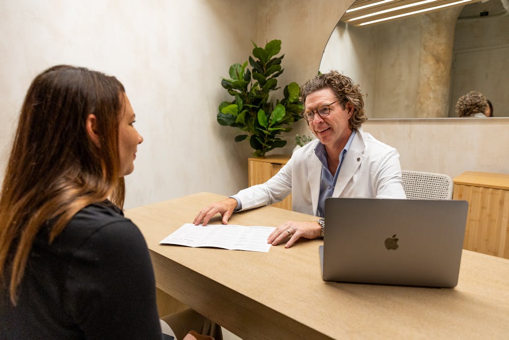 A Lume provider sits down for a consultation with a patient to help her determine if Exion near Lincoln Park Chicago suits her post-weight loss skin laxity needs.