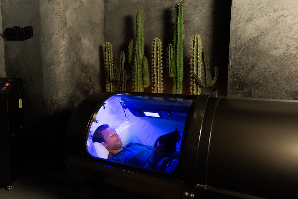 A man lies down in Lume's Hyperbaric Chamber to reduce inflammation in Chicago.
