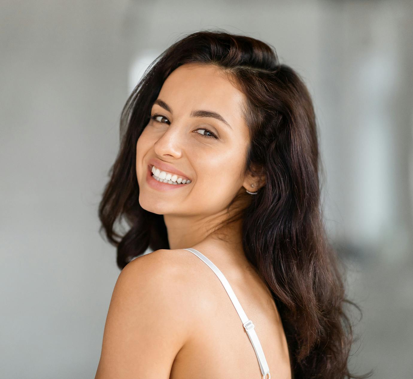 woman looking over shoulder smiling