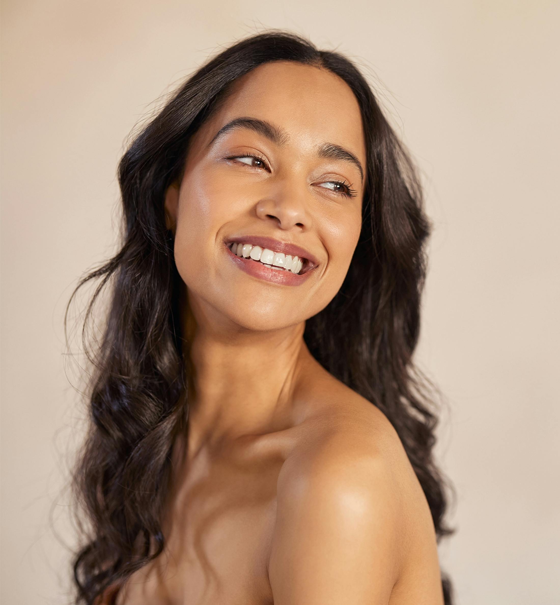 woman looking over shoulder smiling