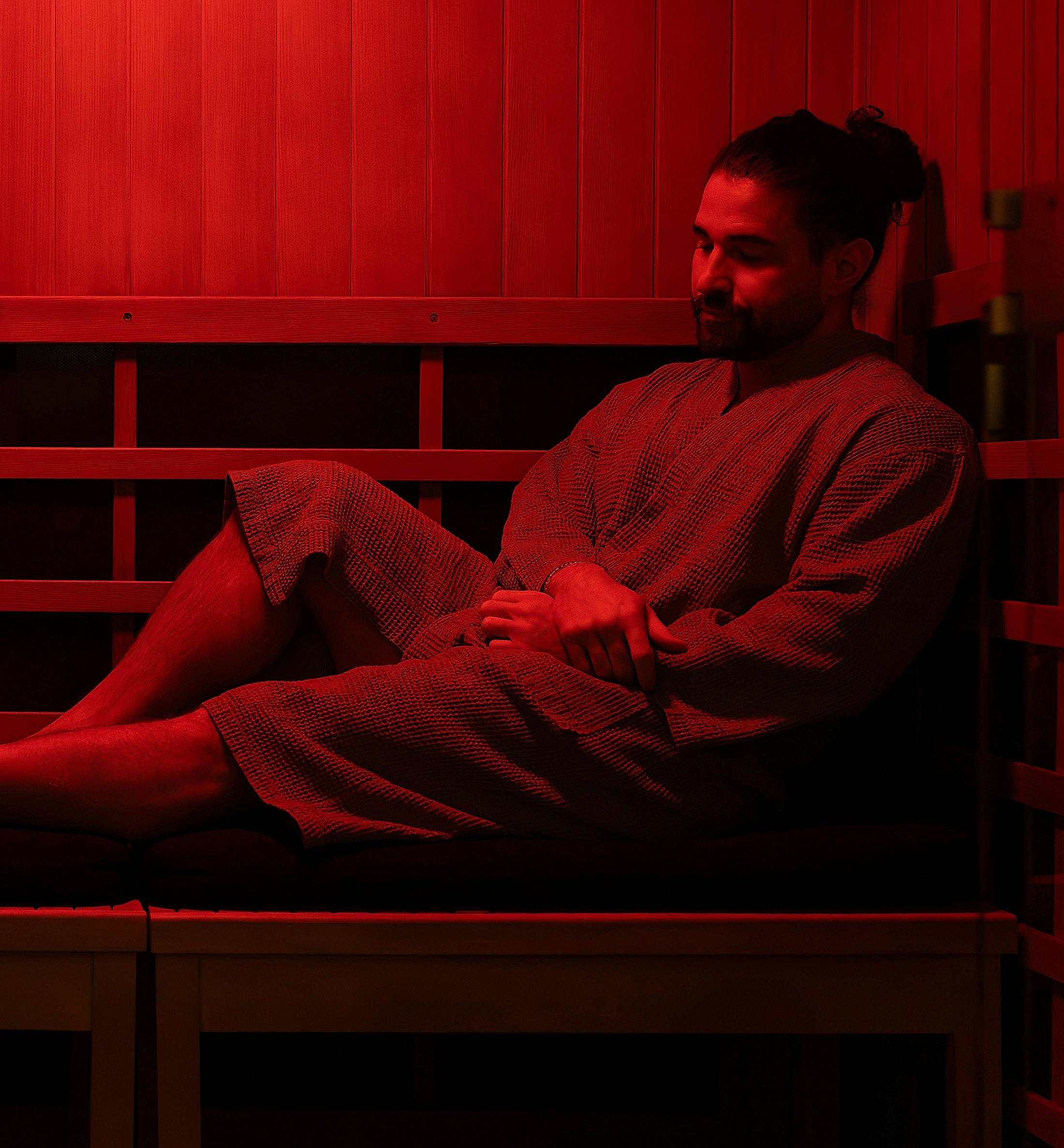 man sitting in sauna
