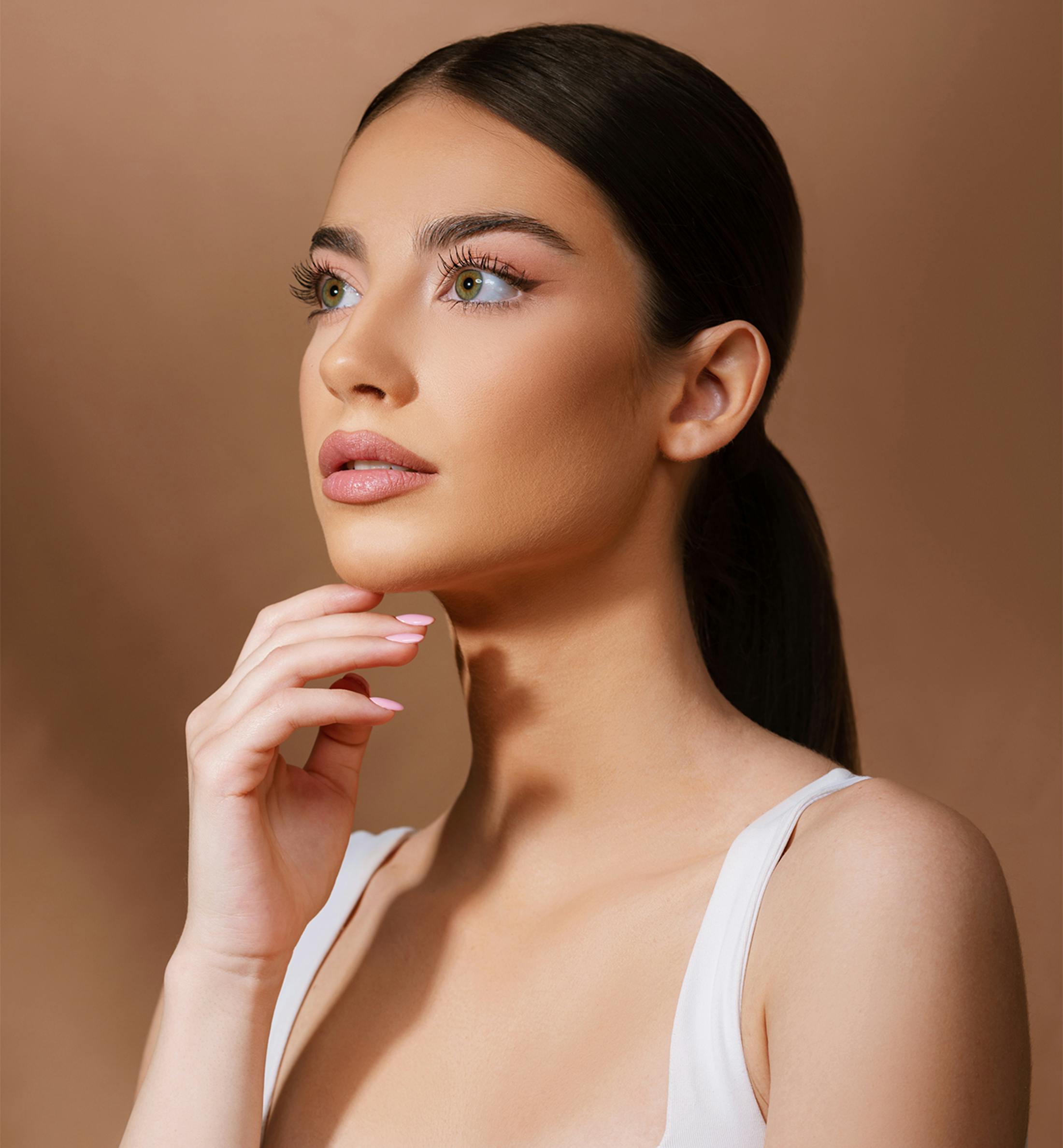 woman looking to the side with hand on chin