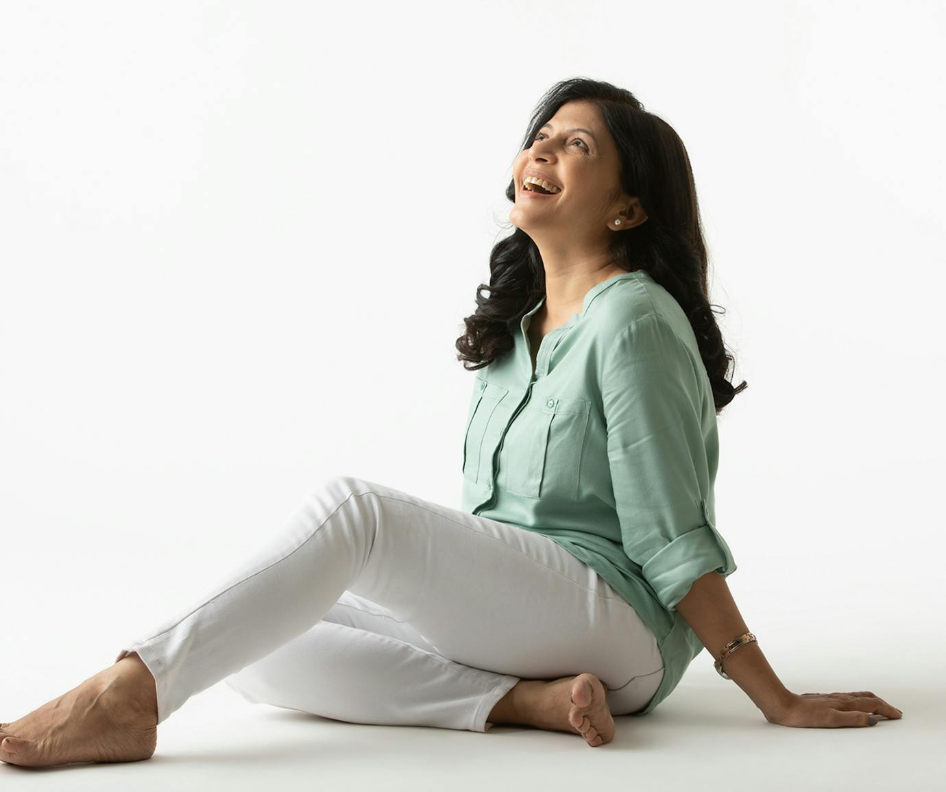 woman sitting on ground laughing