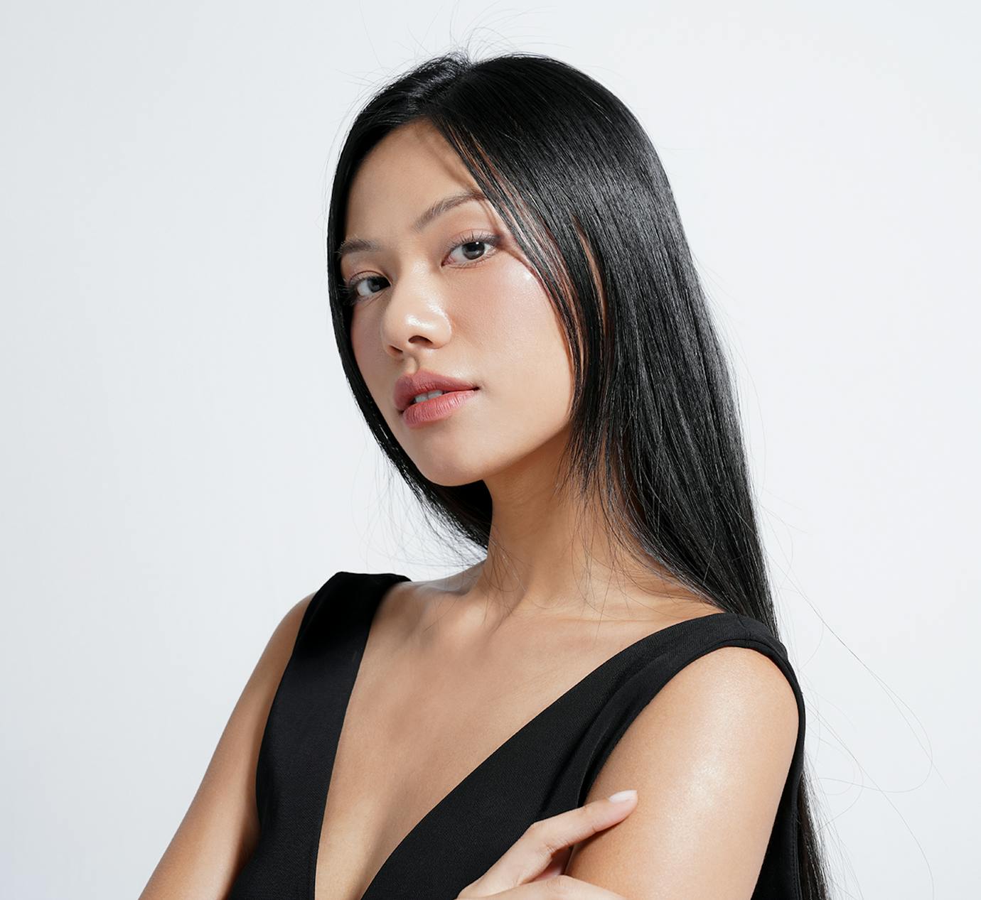 woman with her arms crossed looking over shoulder