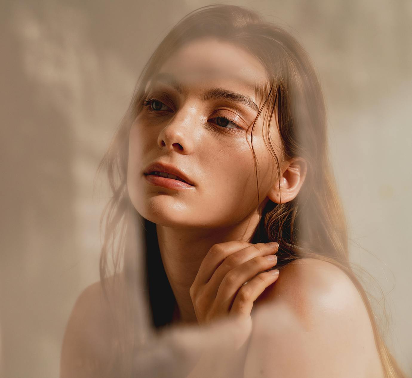 woman looking off with shadows cast over her