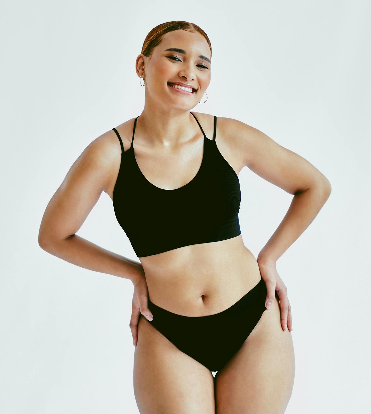 model smiling holding her hips