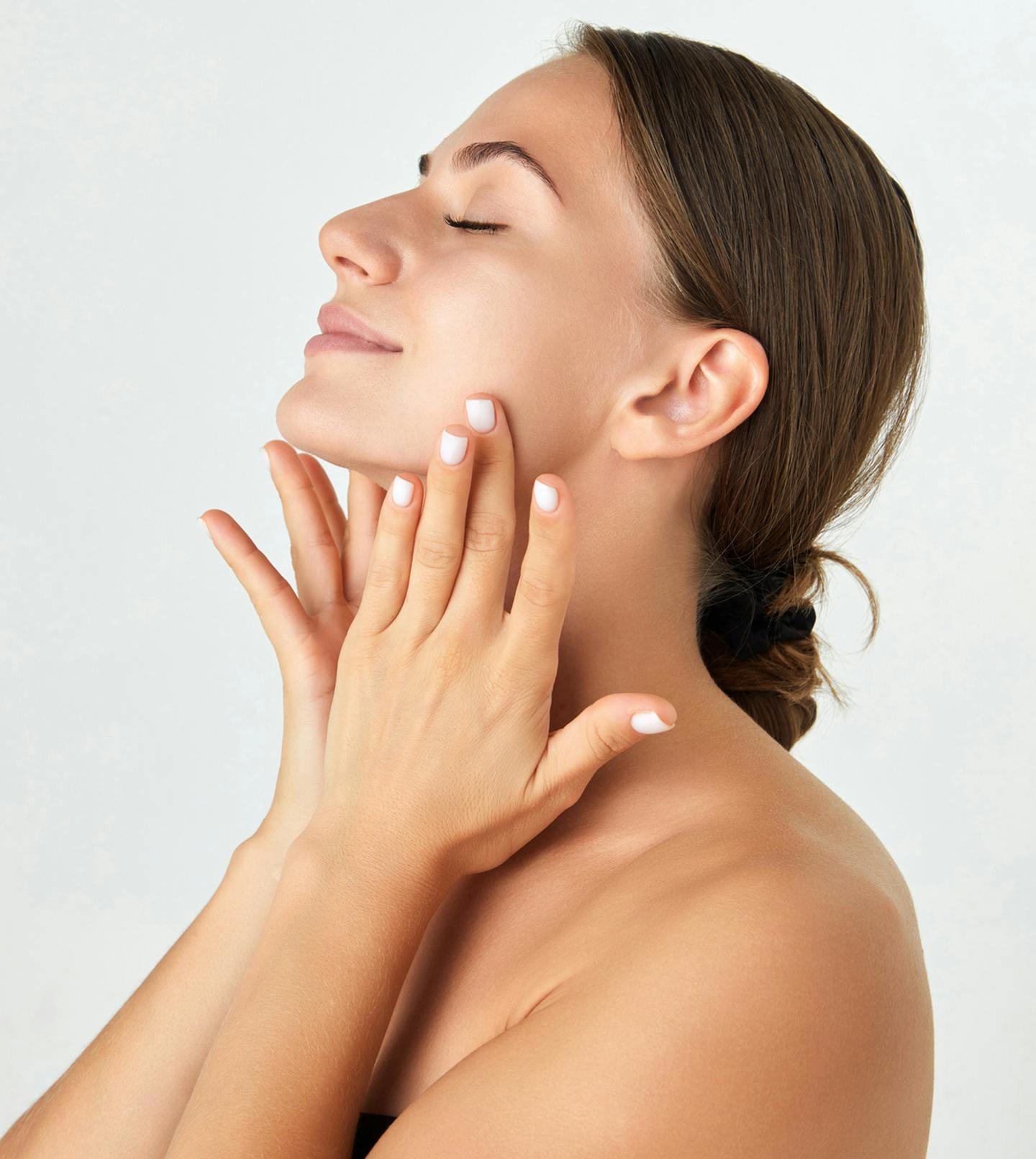 women posing holding her face