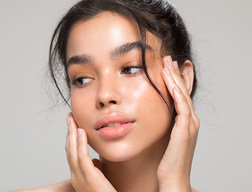 woman touching her face