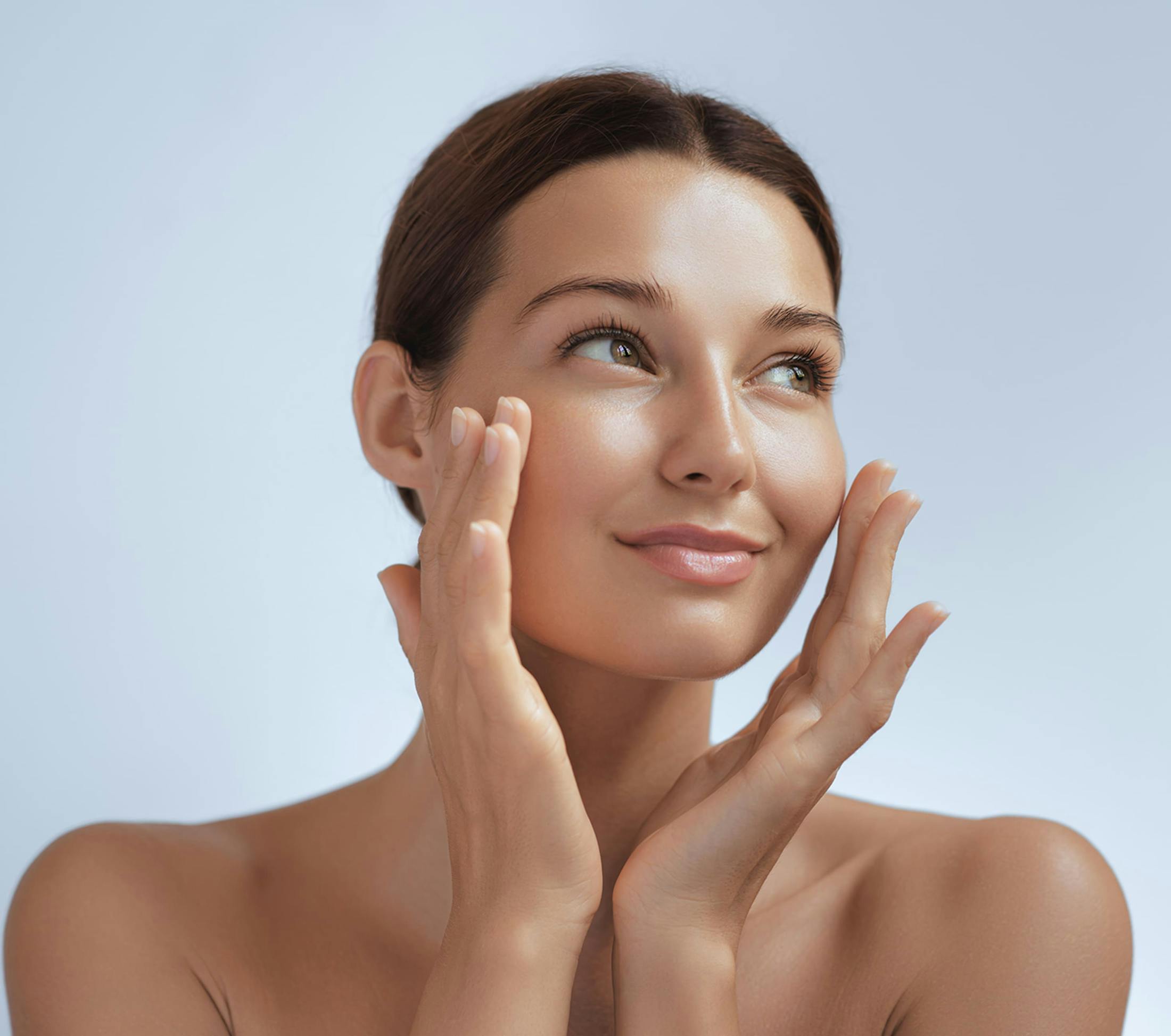 woman touching her cheeks