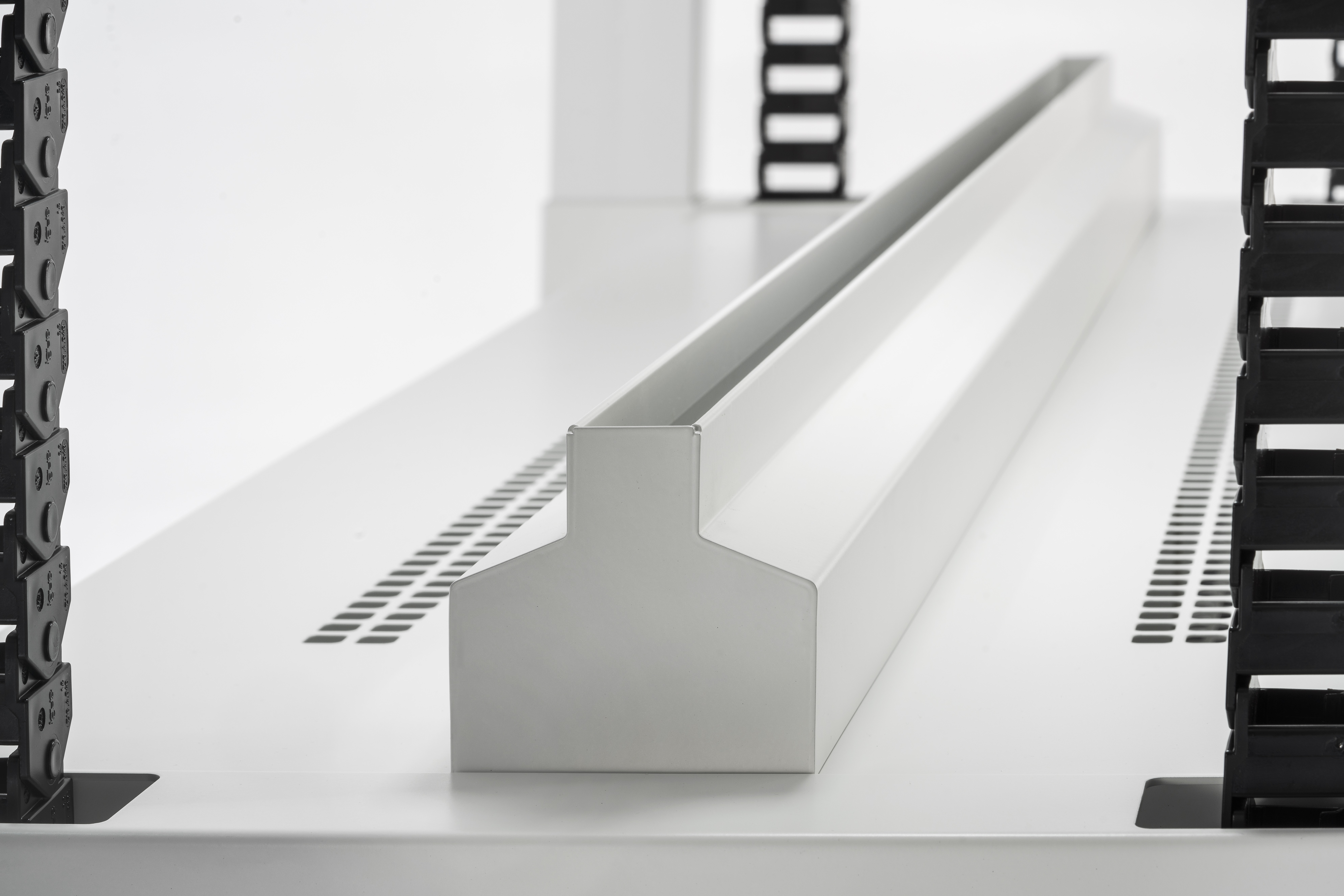 Cable channel with ventilation slots in the frame of a control room console