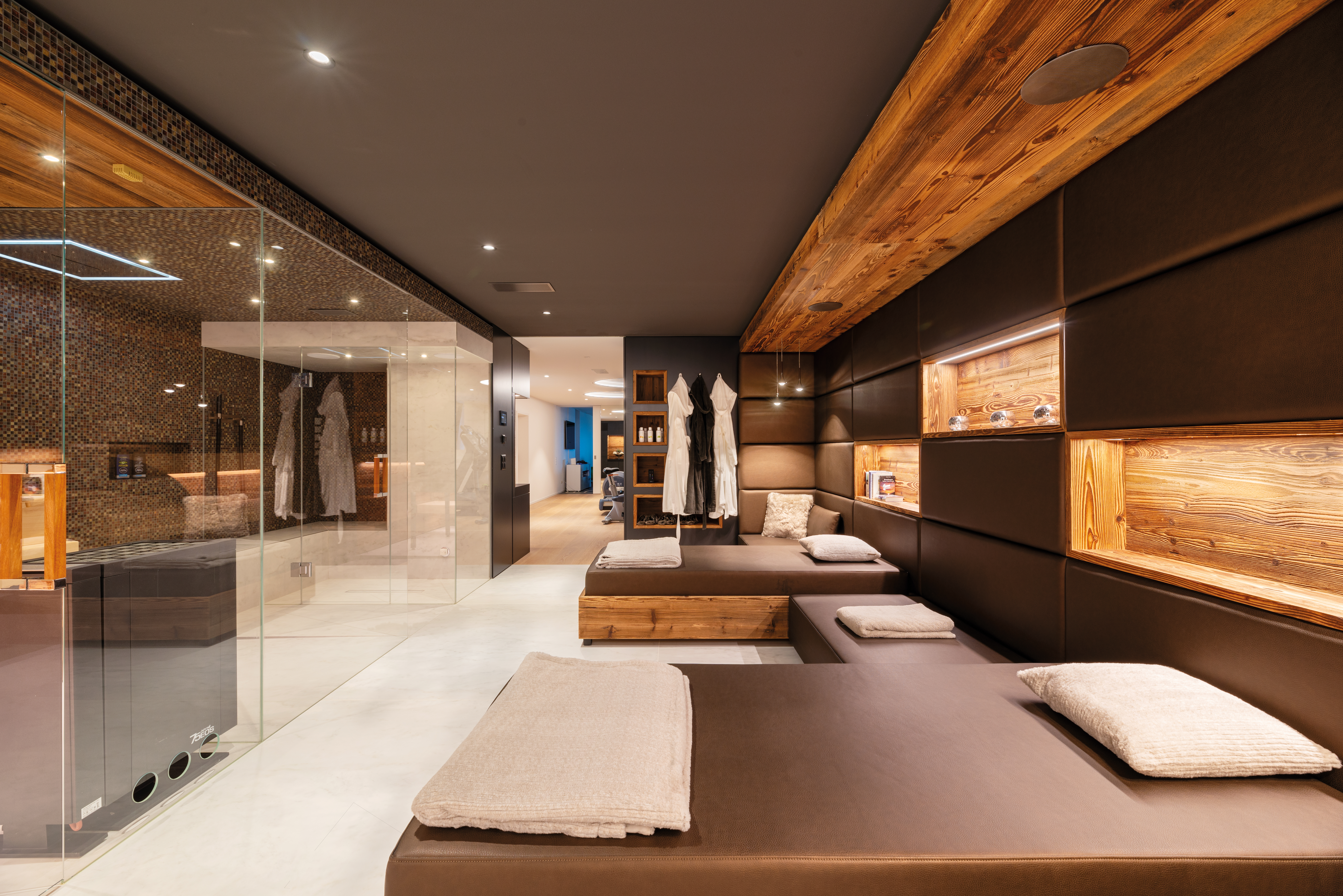 Private wellness area with wood panelling, loungers and steam shower, built by Erich Keller