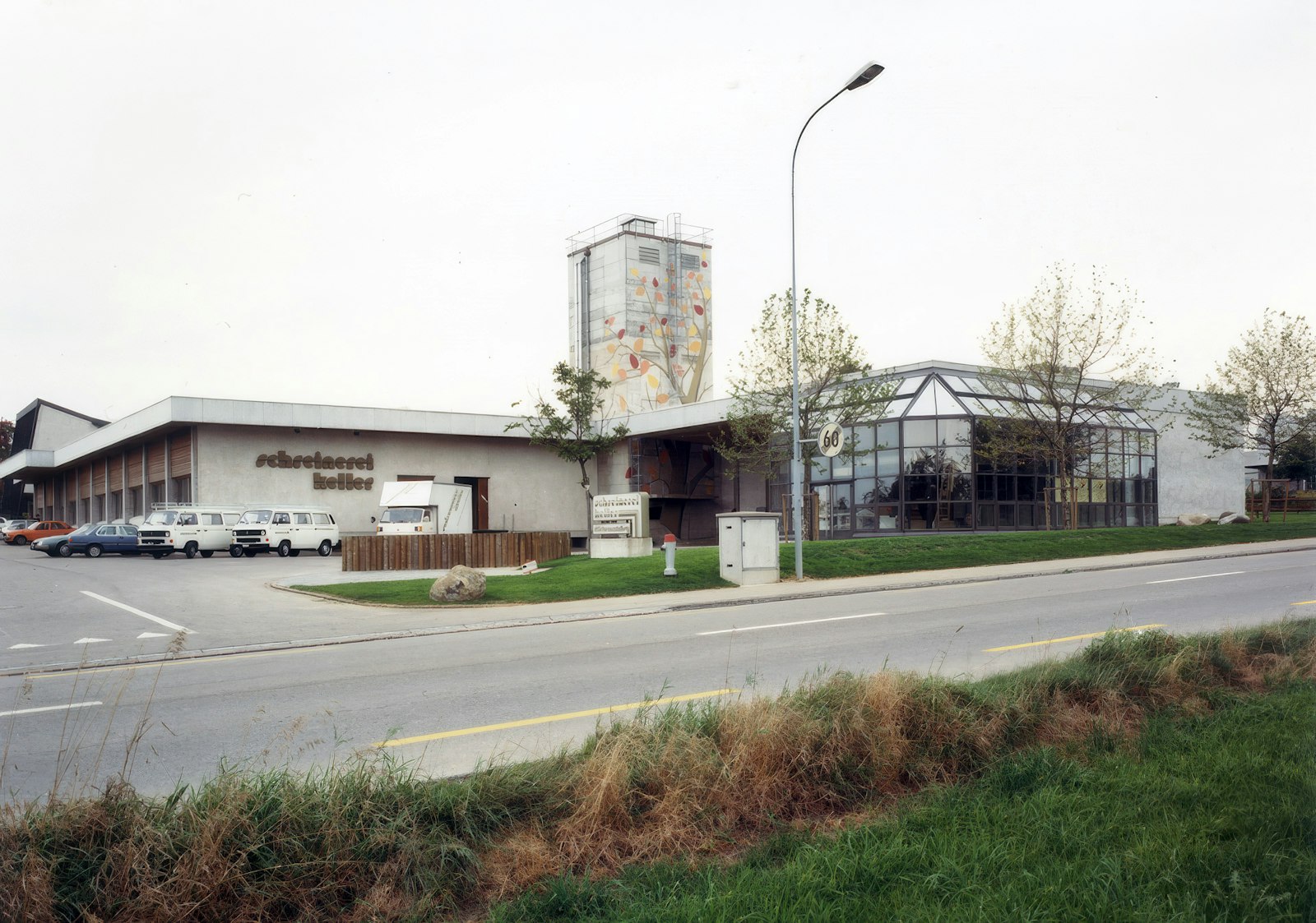 Extended Schreinerei Keller building with a glass annex and a '60' anniversary sign