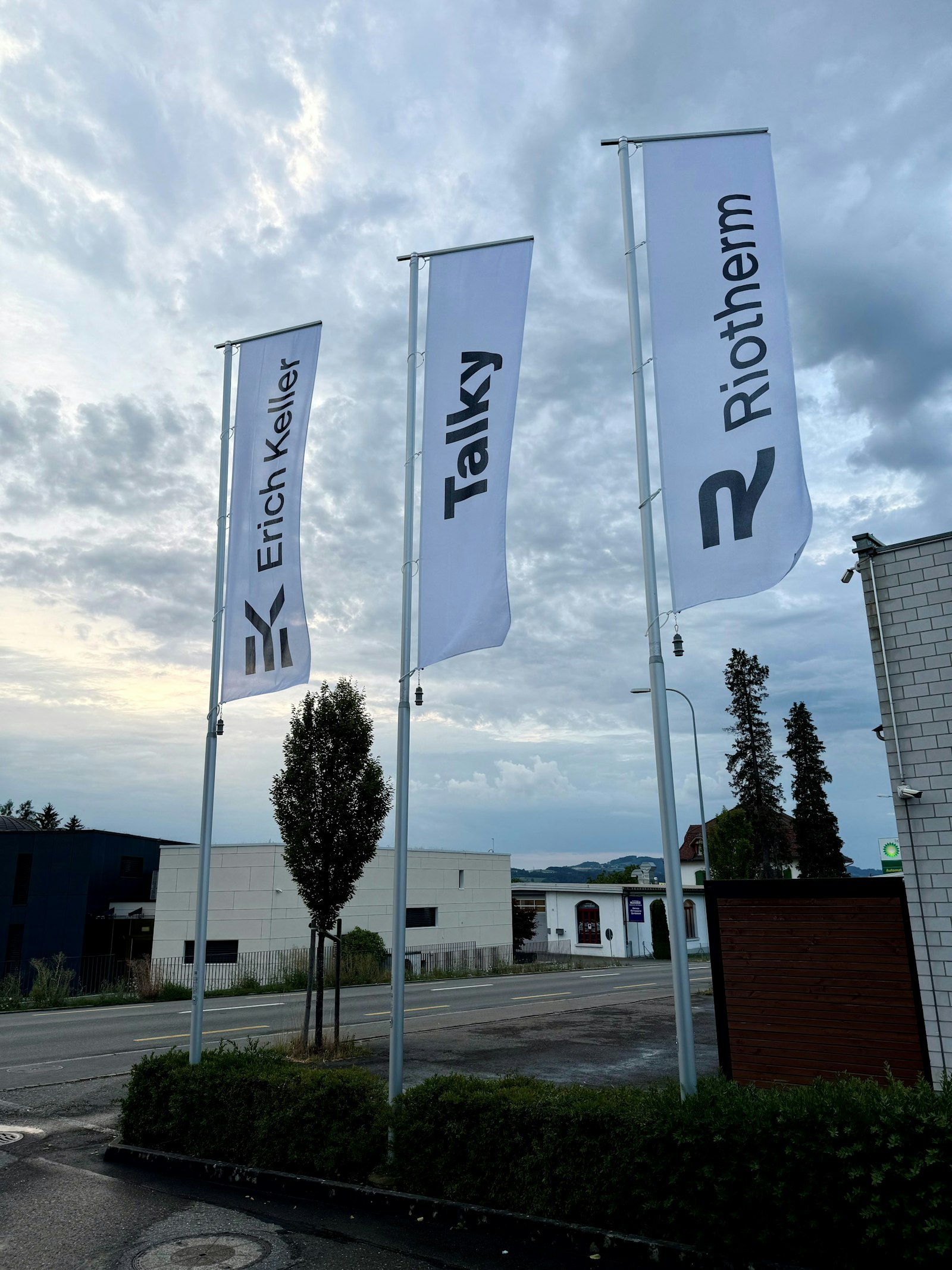 Flags bearing the Erich Keller, Talky and Riotherm brands outside the company building