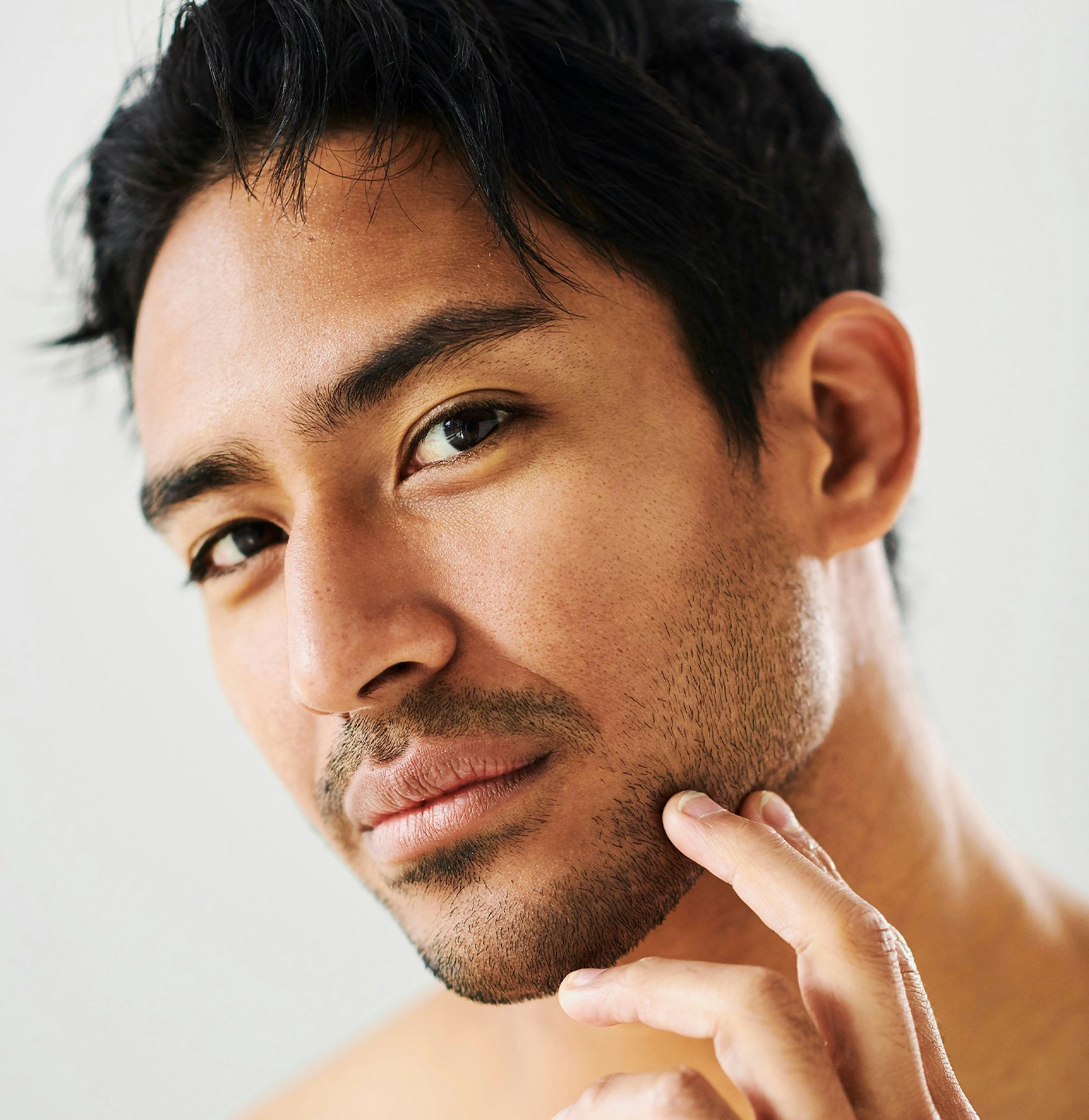 man holding his face