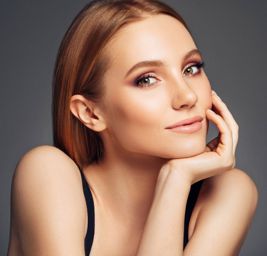 Woman touching her face
