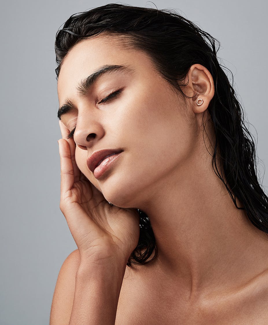 woman touching the side of her face