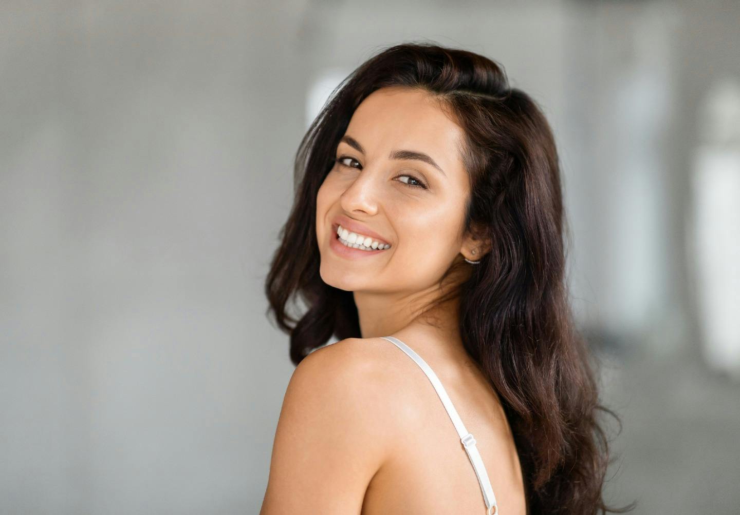 woman with long brown hair smiling
