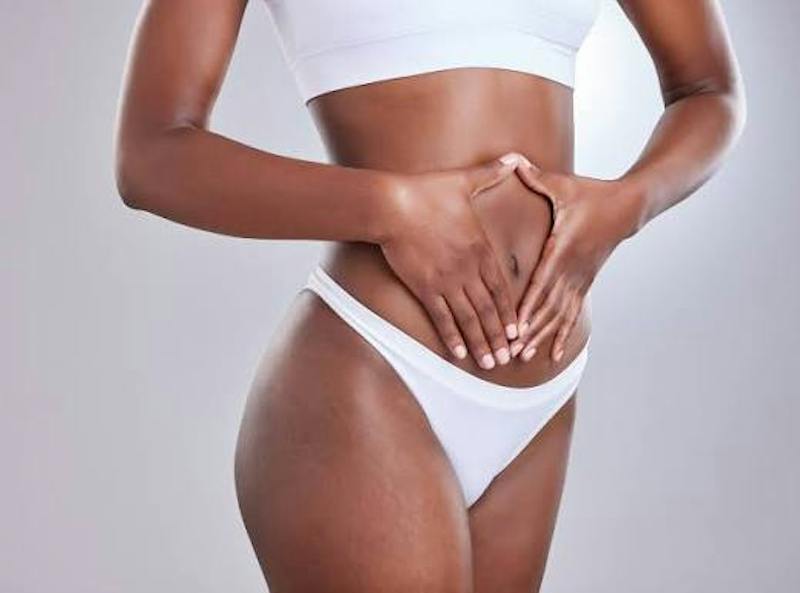 Tummy tuck holding stomach