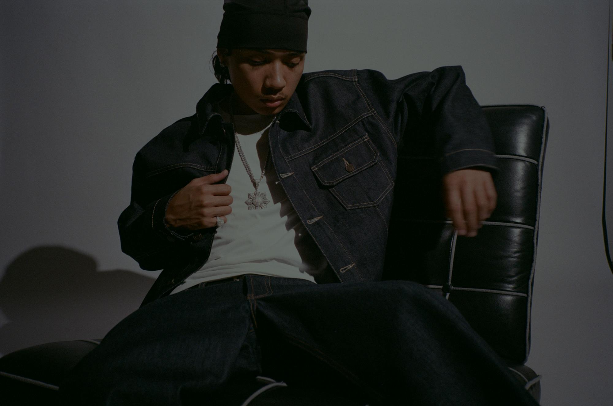 Pino sitting on a black leather chair