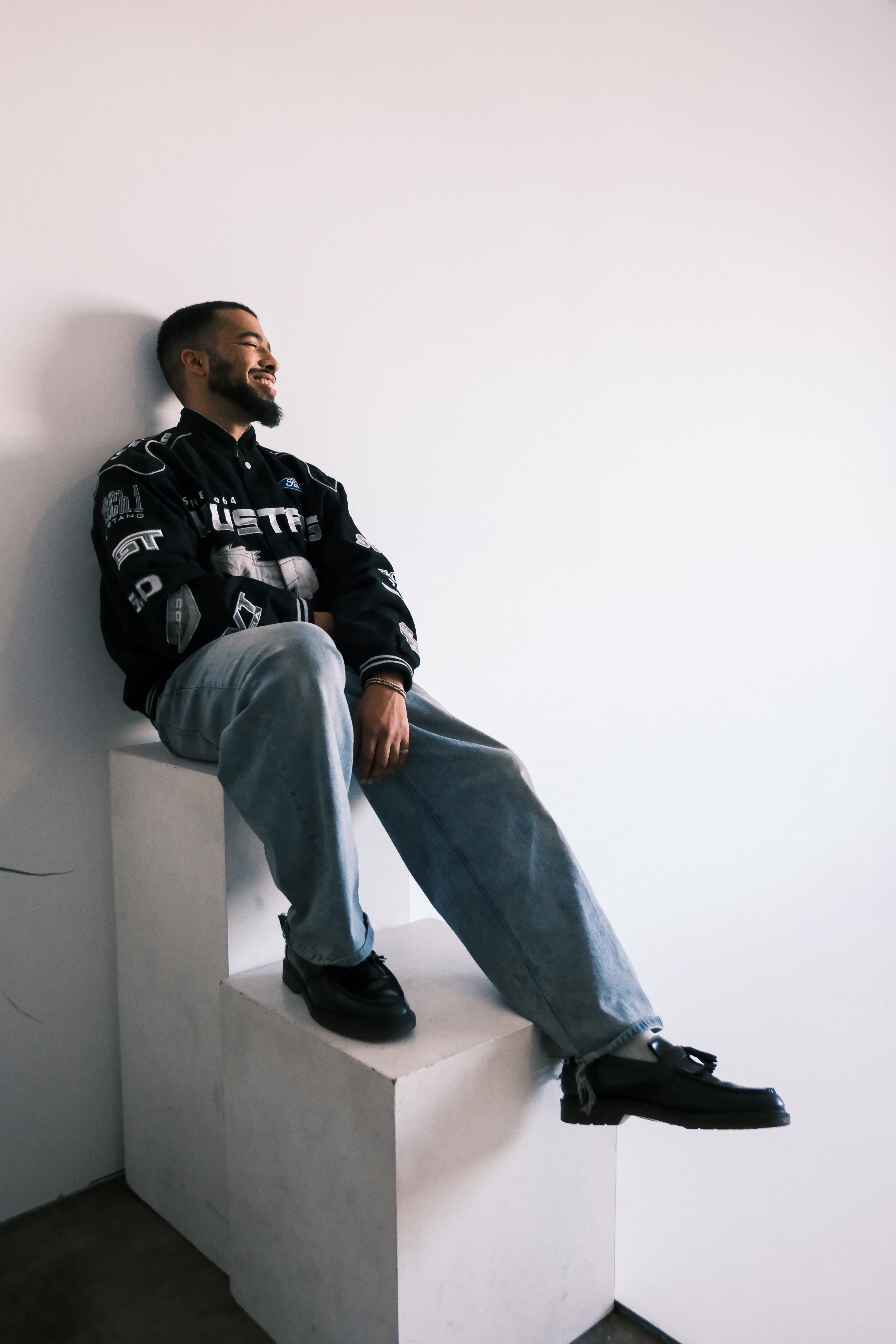 mynameisntjmack sitting on white blocks