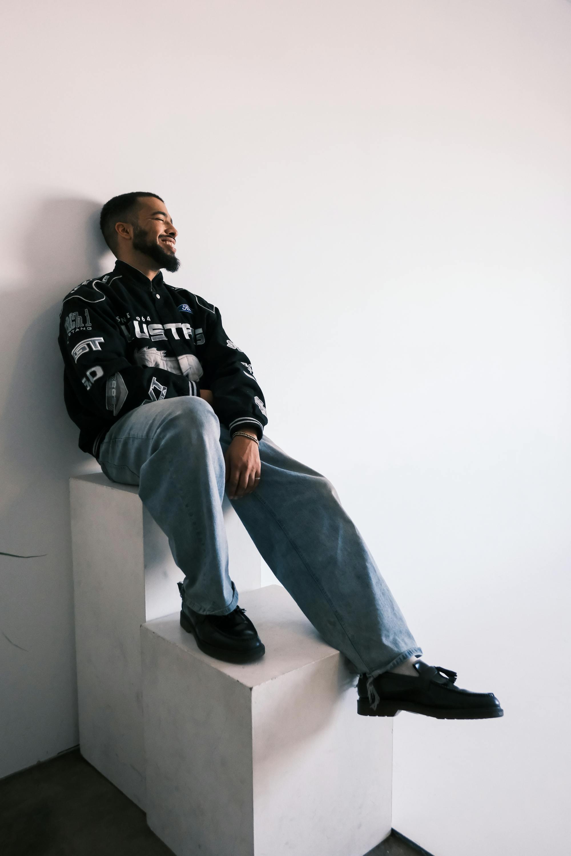mynameisntjmack sitting on white blocks
