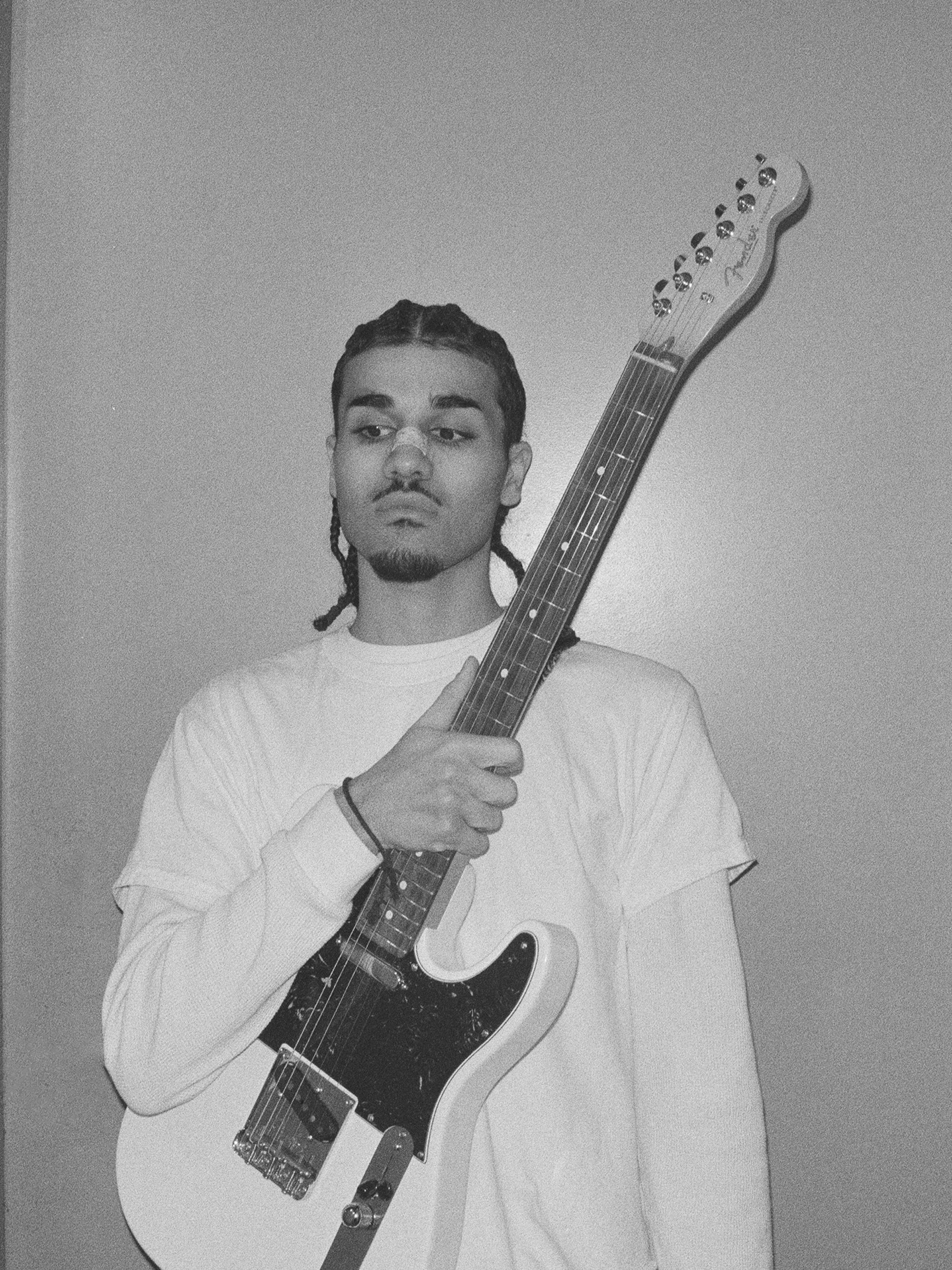 Maz B holding a Fender Telecaster electric guitar