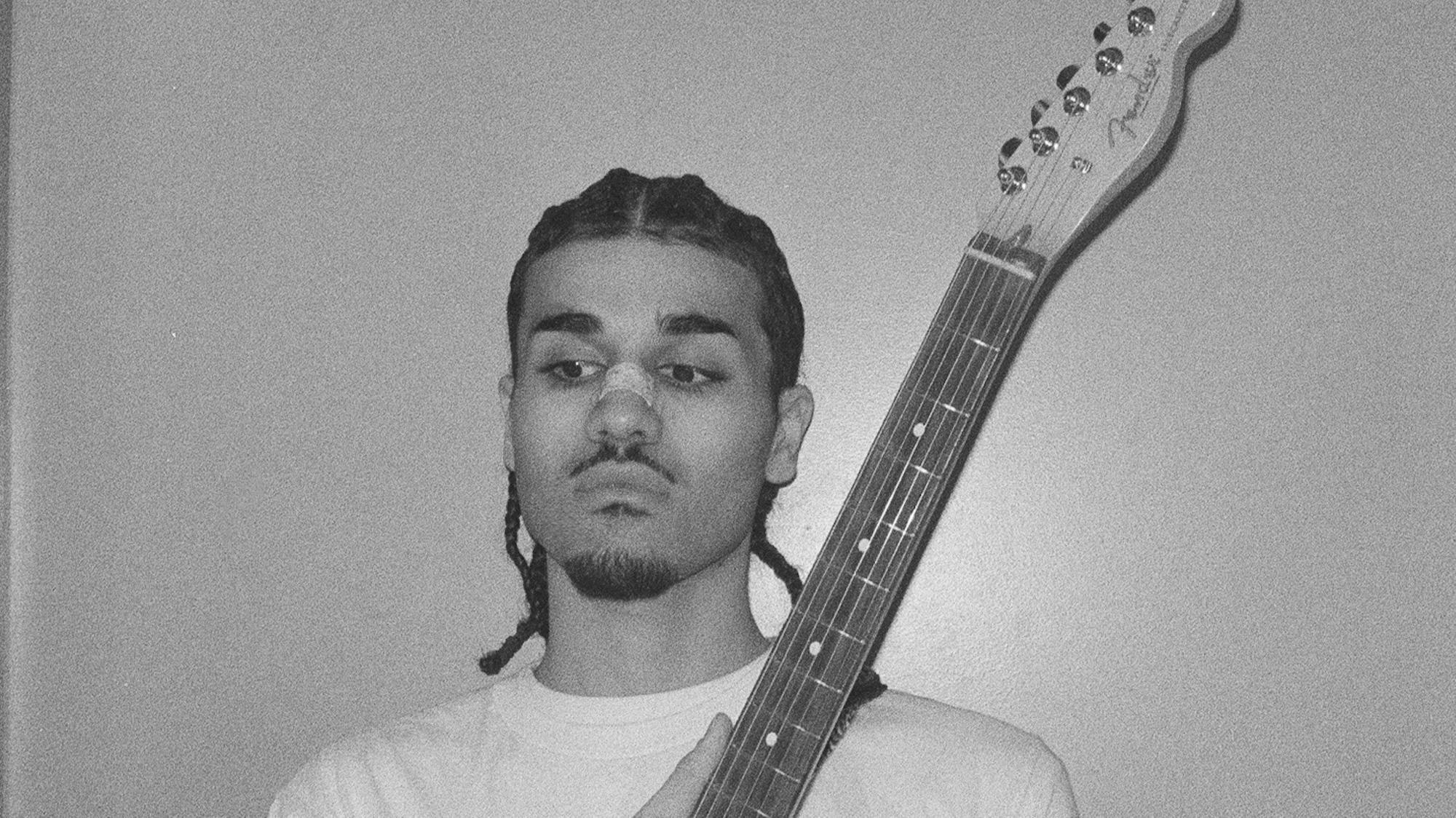 Maz B holding a Fender Telecaster electric guitar
