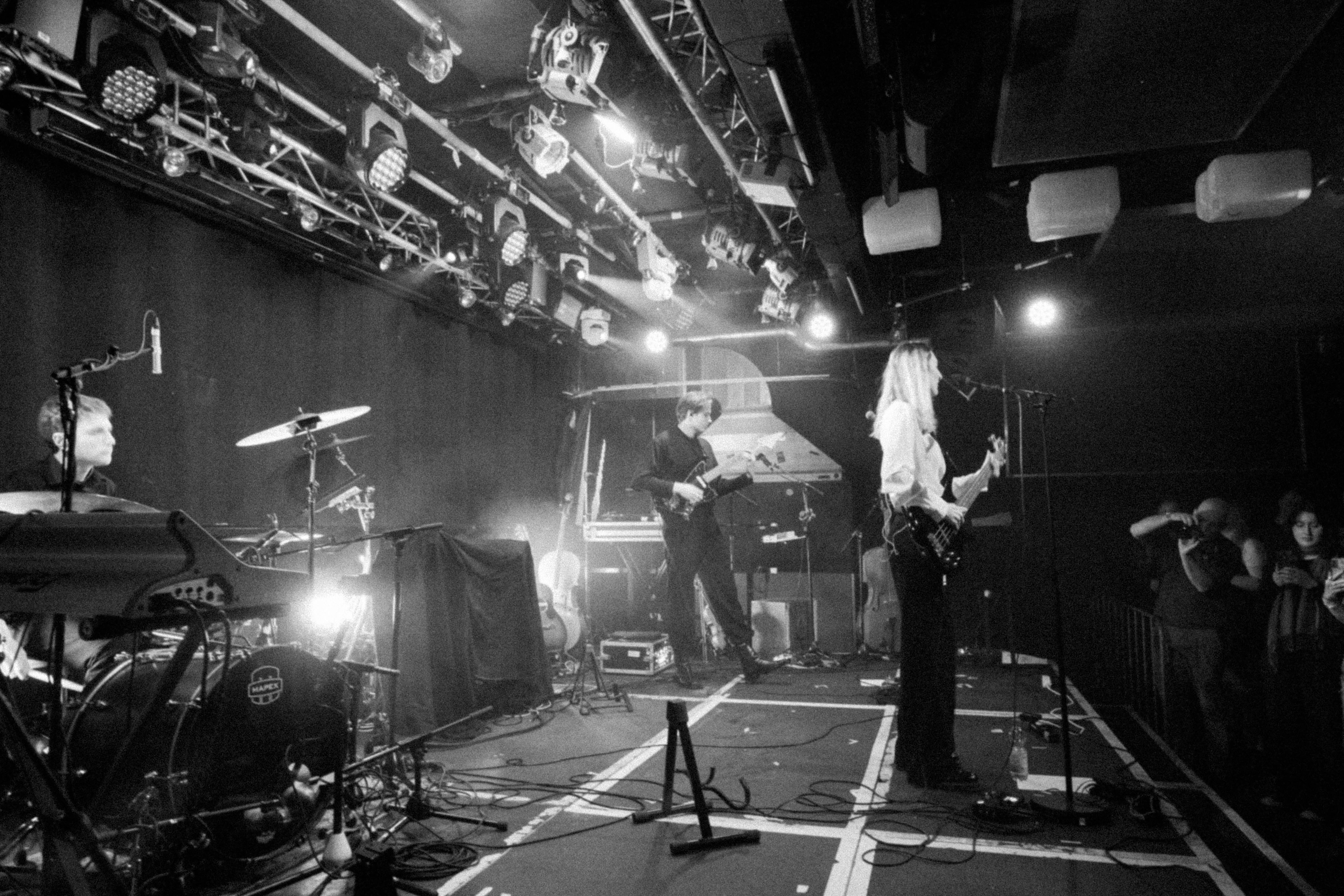 nothhingspecial on stage with a band at an indoor music venue