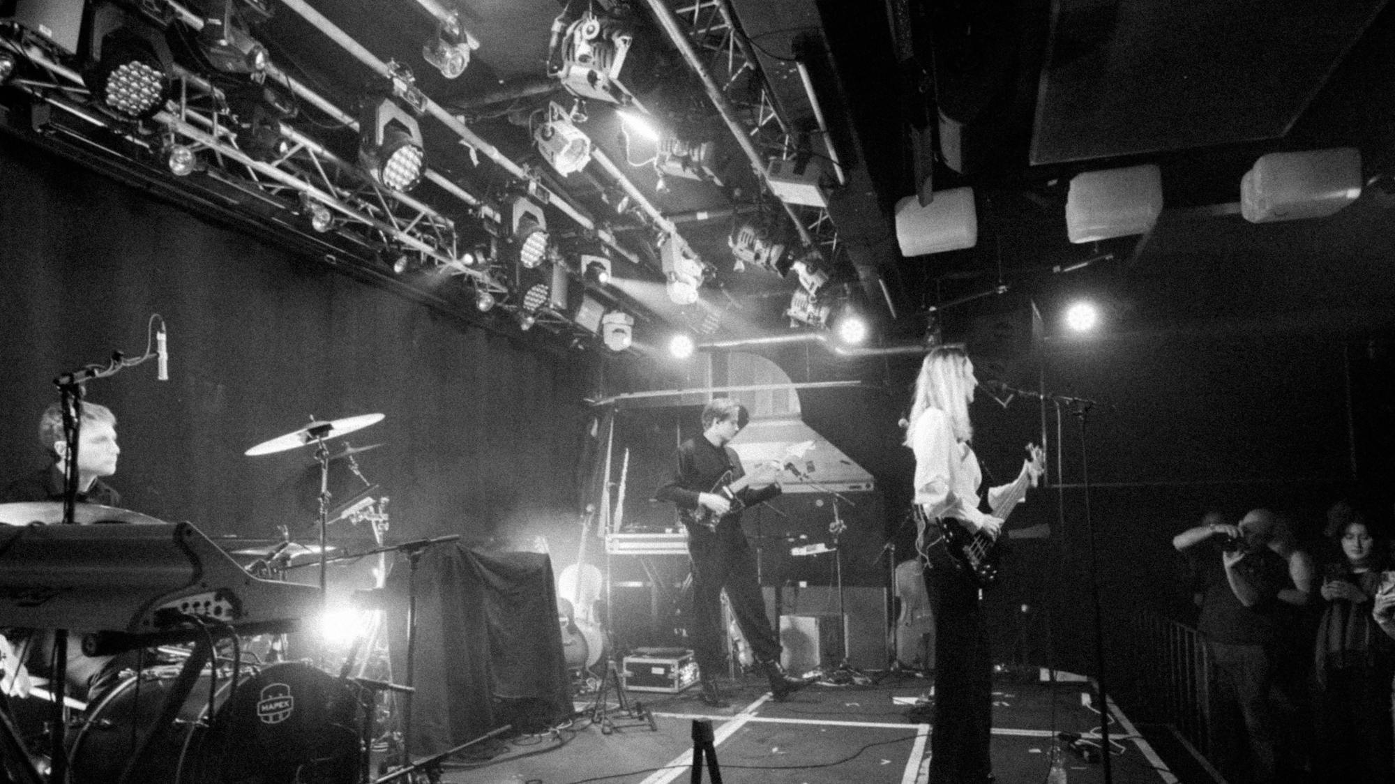 nothhingspecial on stage with a band at an indoor music venue