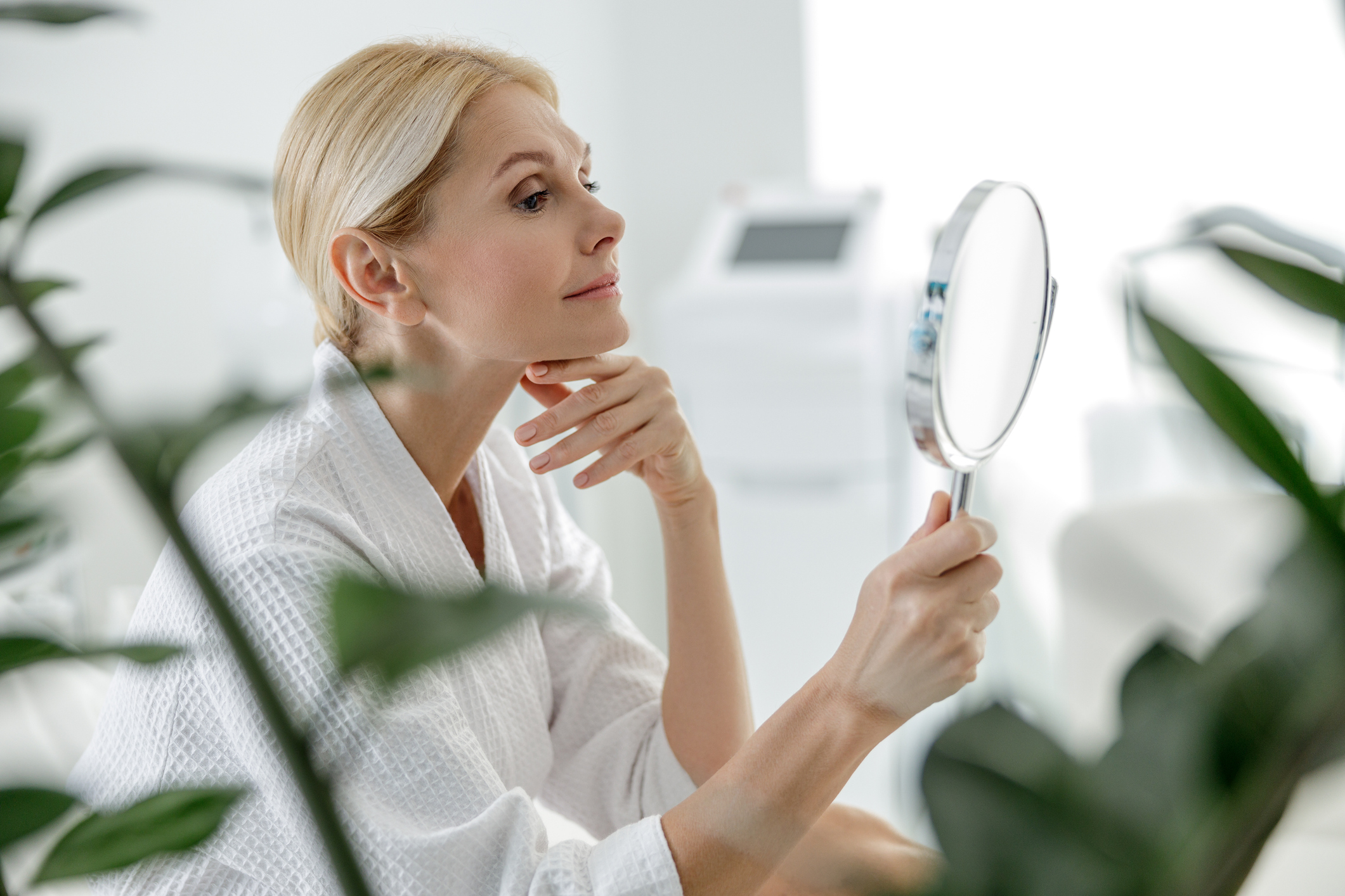 woman looking into mirror