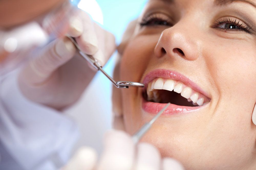 A woman with healthy looking teeth undergoing a dental exam