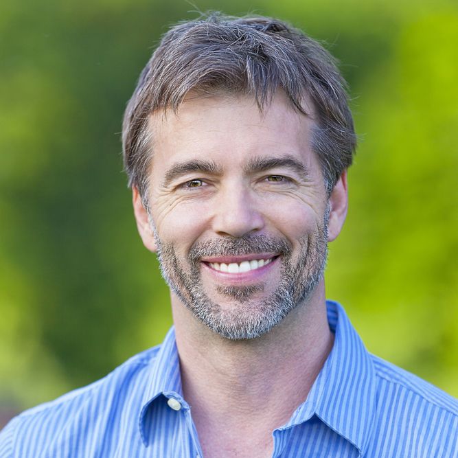 A man with healthy, bright white teeth, smiling