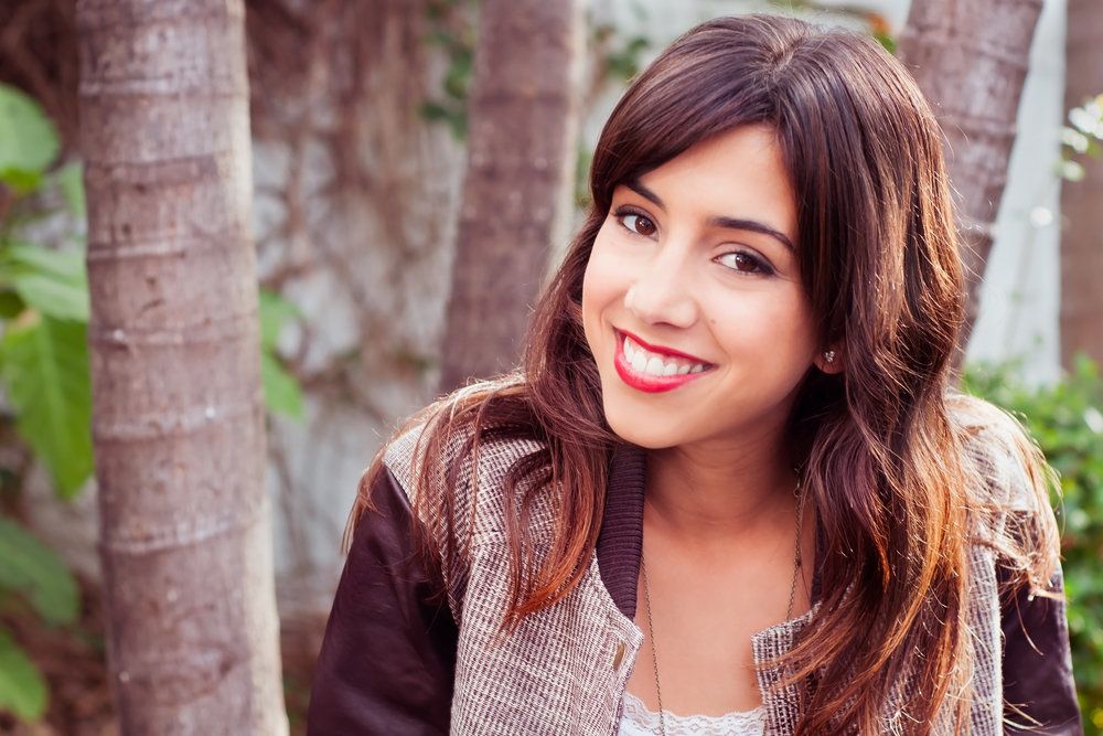 Woman smiling by trees