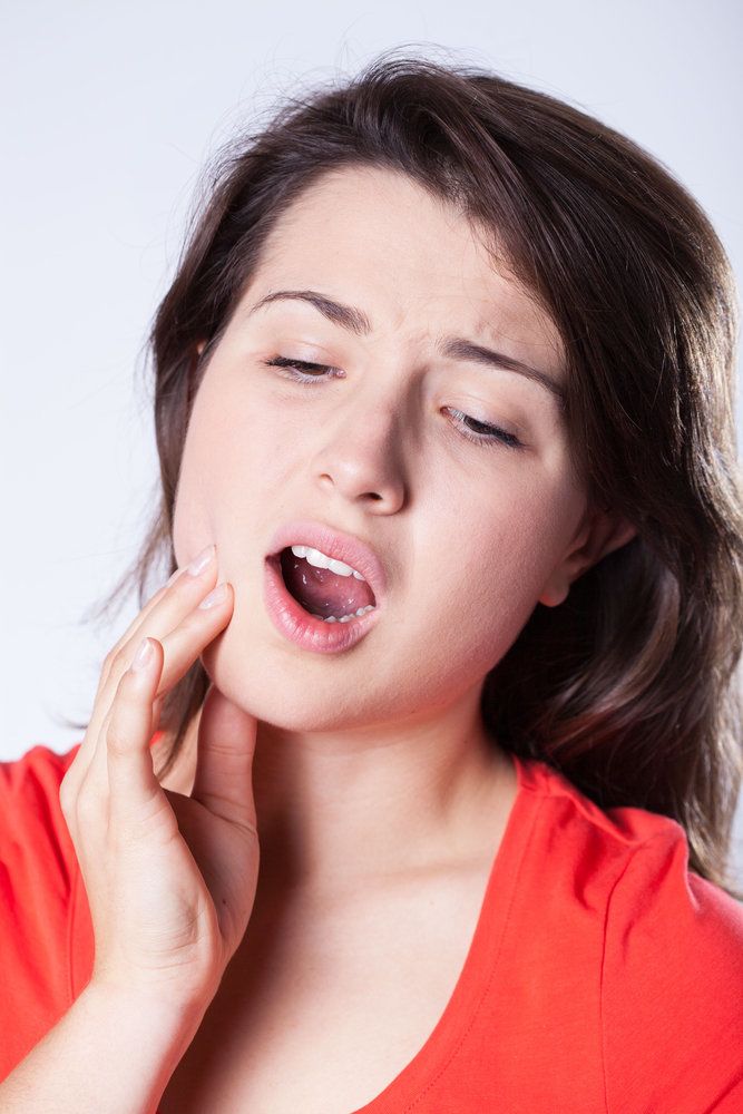 A woman with a toothache and jaw pain