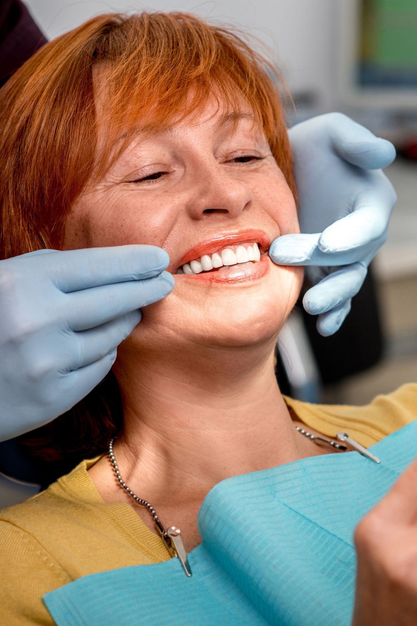 A woman smiling at the dentist's office