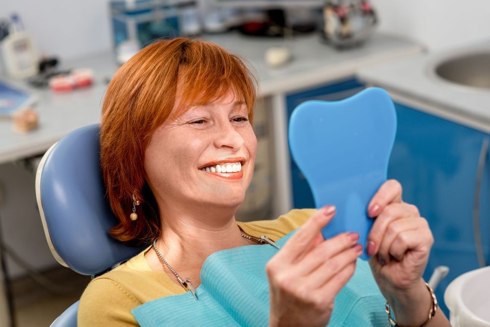 A woman smiling in the dentist's chair