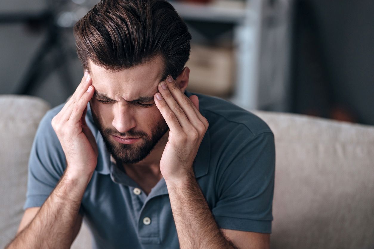 Male suffering from complications of TMJ disorder