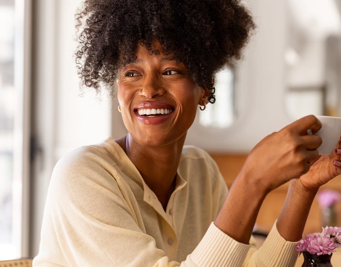 smiling woman holding cup