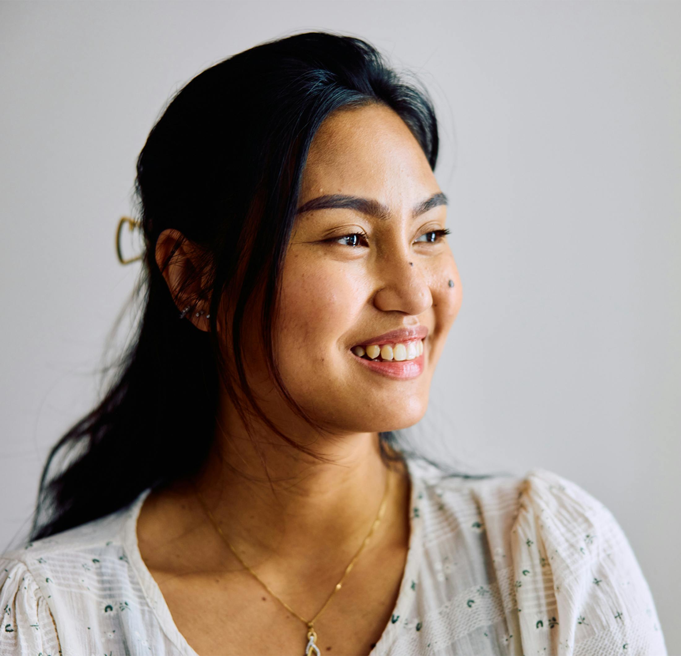 Woman smiling and looking off to the side