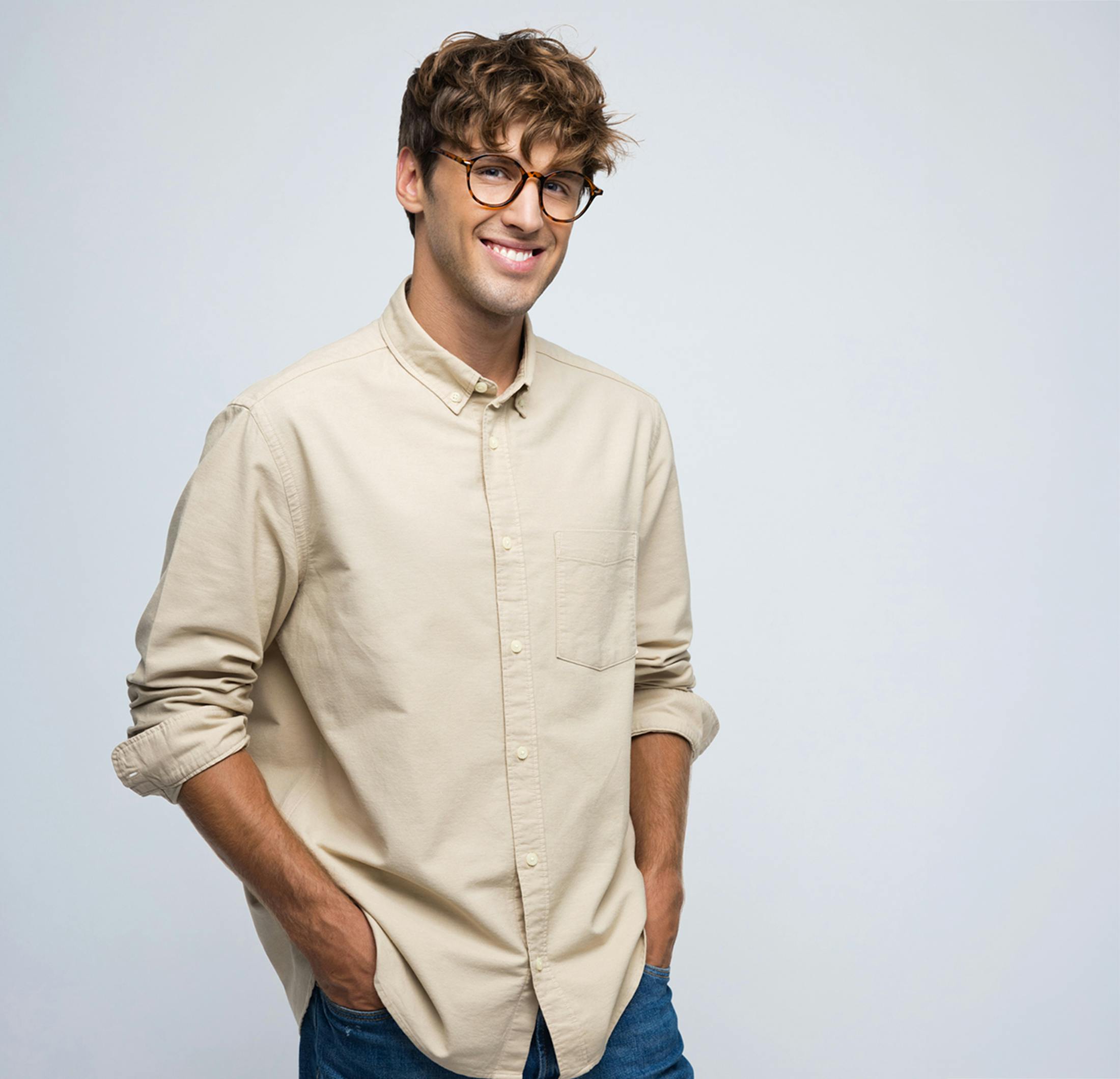 Man smiling with his hands in his pockets