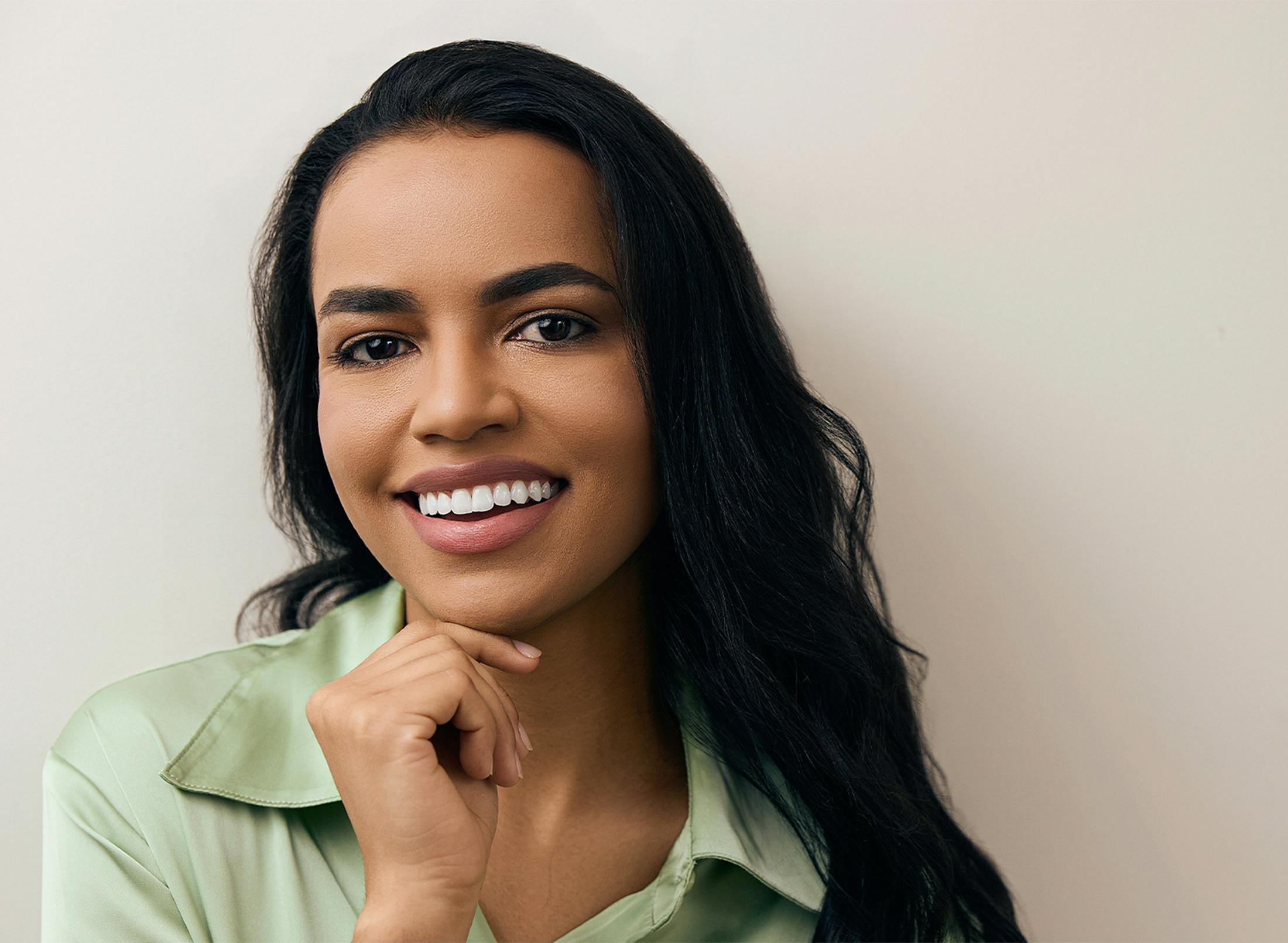 Woman smiling and touching her chin