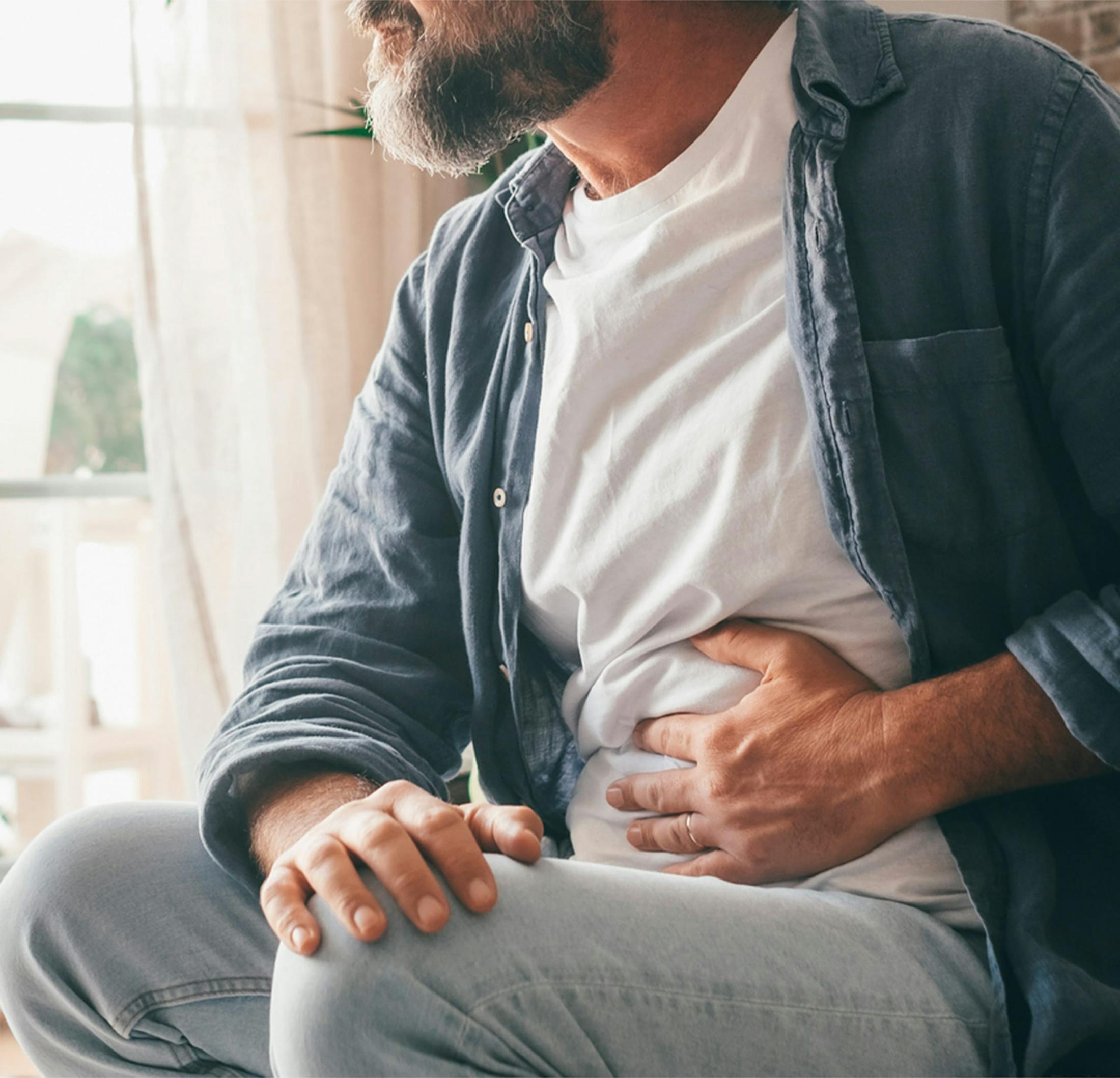 man holding stomache
