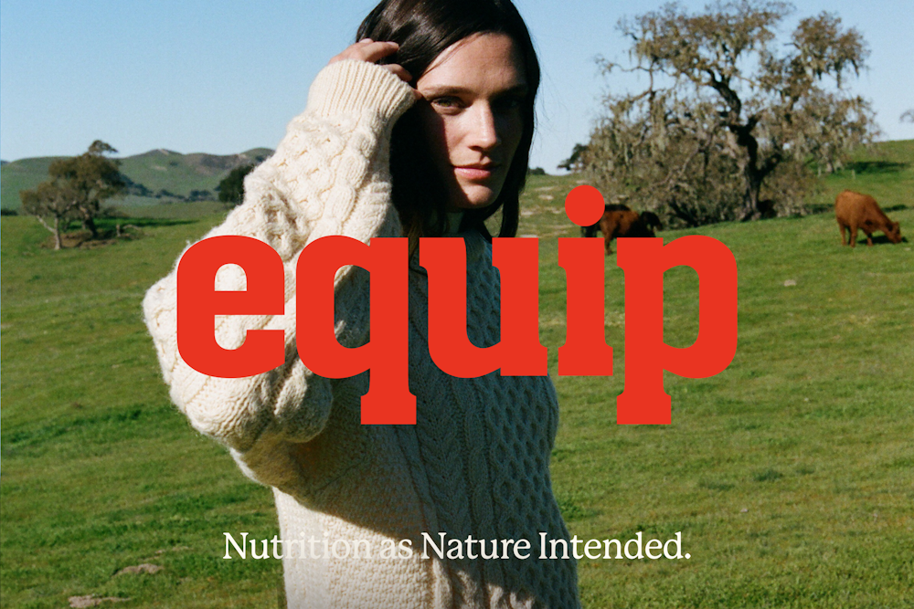 A person in a cream sweater stands in a grassy field with cows and trees. Large red text reads “equip.” Smaller text below reads, “Nutrition as Nature Intended.”.