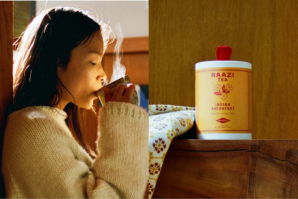On the left, a women enjoying her tea. On the right, a Raazi Tea Indian Breakfast packaging on a wood shelf.