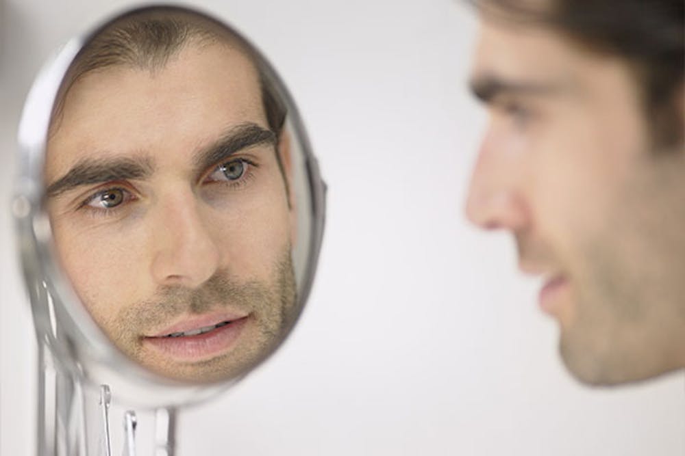 man looking in the mirror