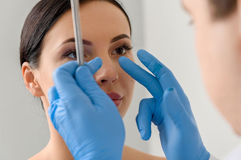 woman getting rhinoplasty consultation