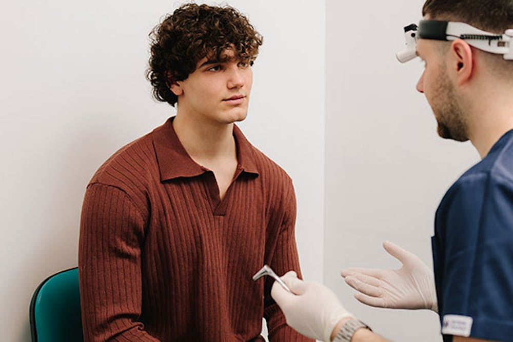 blog-rhinoplasty-preparation-10-key-questions-to-ask-your-surgeon-2 man getting a rhinoplasty consultation in Miami, FL