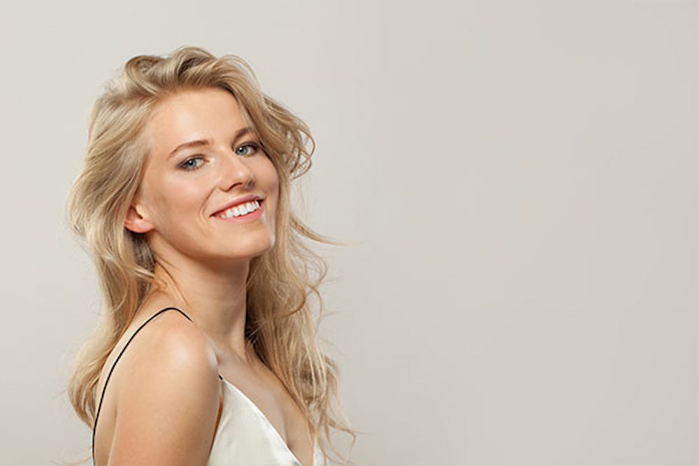 blog-how-hair-restoration-differs-box-1 woman smiling after getting hair restoration in Miami, FL