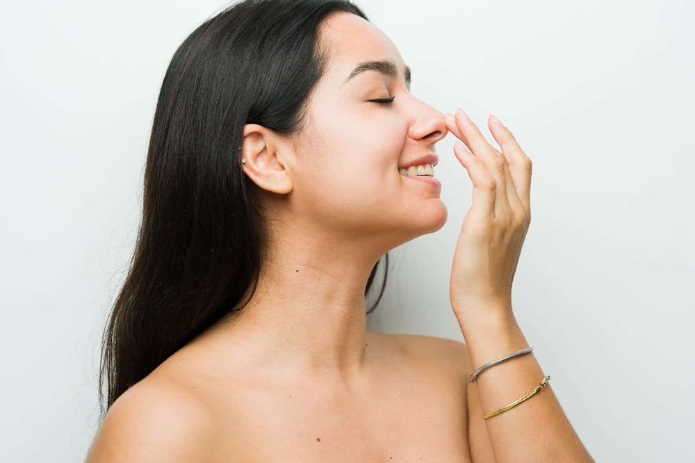 woman after getting a revision rhinoplasty in Miami, FL