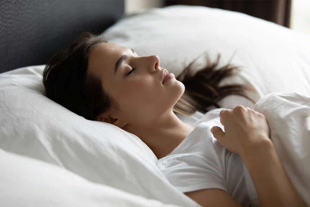woman sleeping after her rhinoplasty in Miami, FL